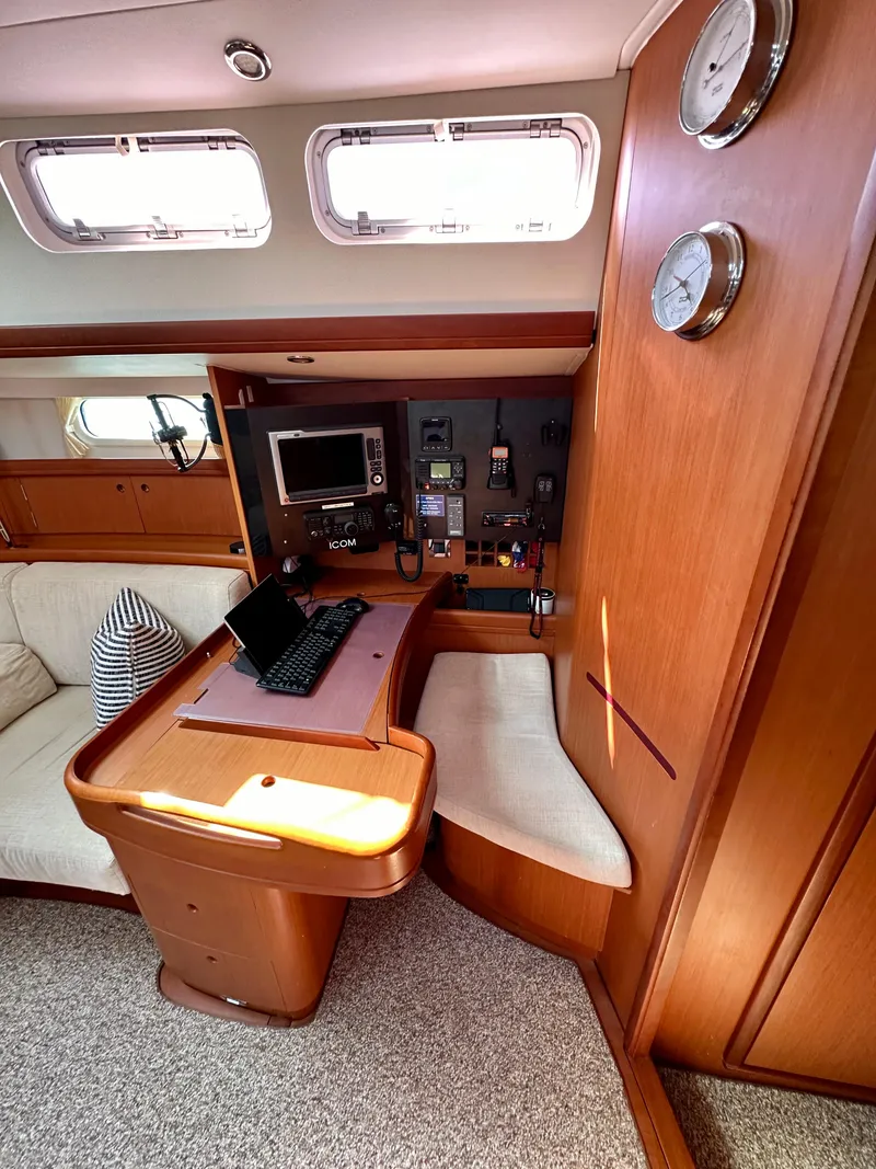 Slide: The Image of Interior of 2010 Beneteau 57 yacht with navigation station and seating area. - 34