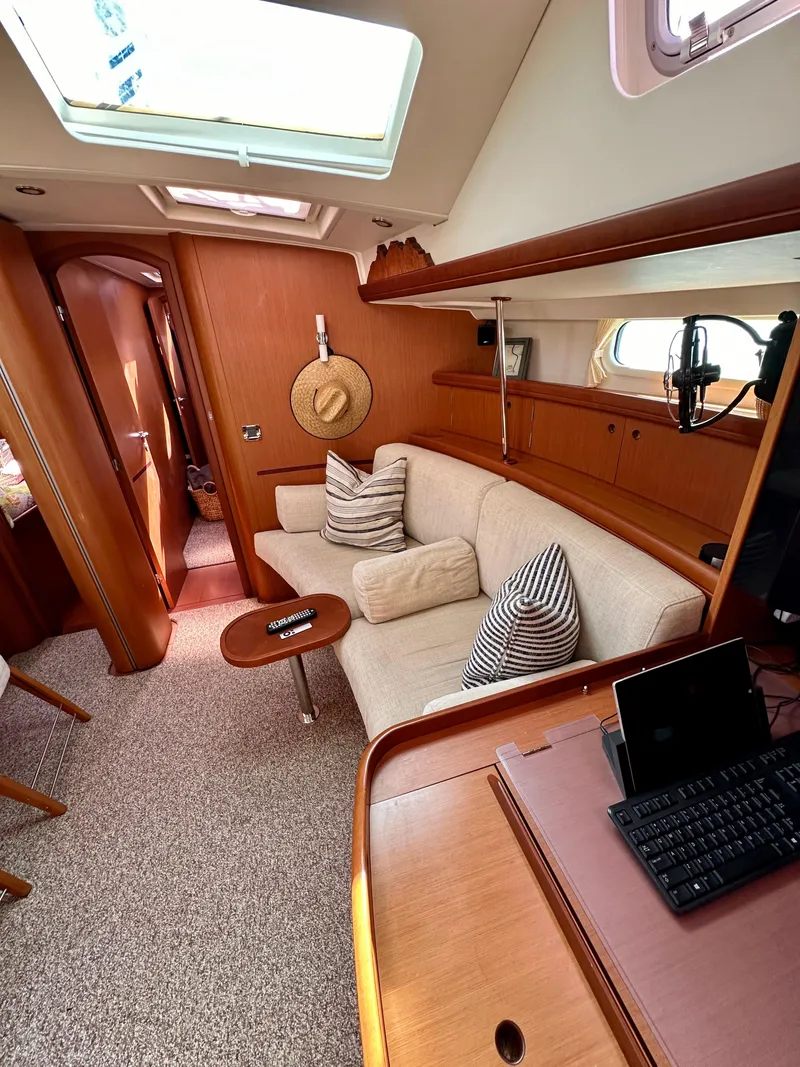 Slide: The Image of Interior of 2010 Beneteau 57 yacht with cozy seating and natural light. - 36
