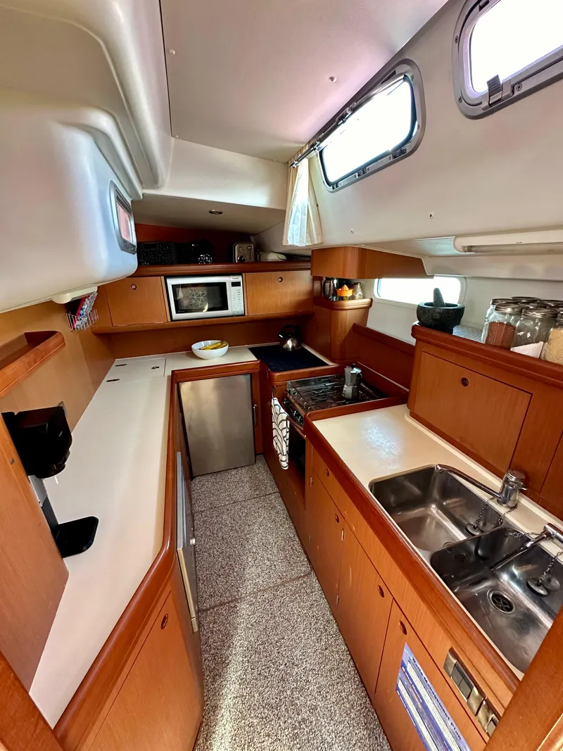 Slide: The Image of Spacious kitchen in 2010 Beneteau 57 yacht with modern appliances and wooden cabinetry. - 39