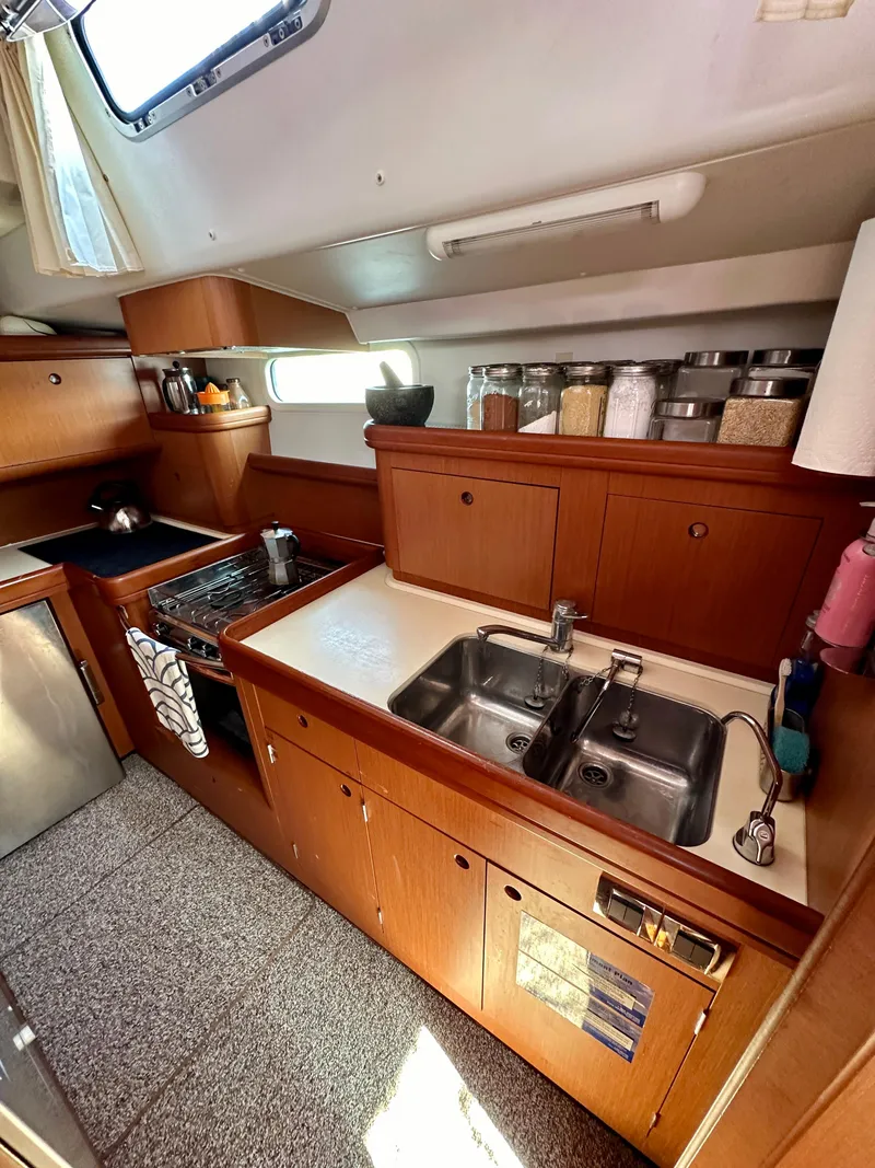 Slide: The Image of Spacious galley in 2010 Beneteau 57 yacht with dual sinks and ample storage. - 41