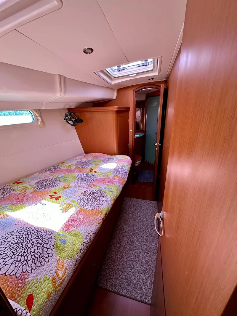 Slide: The Image of Cozy cabin interior of 2010 Beneteau 57 yacht with colorful bedding and natural light. - 43