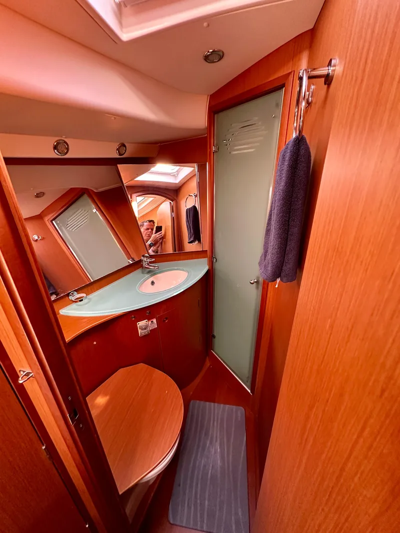 Slide: The Image of 2010 Beneteau 57 yacht bathroom with wooden interior and modern fixtures. - 44