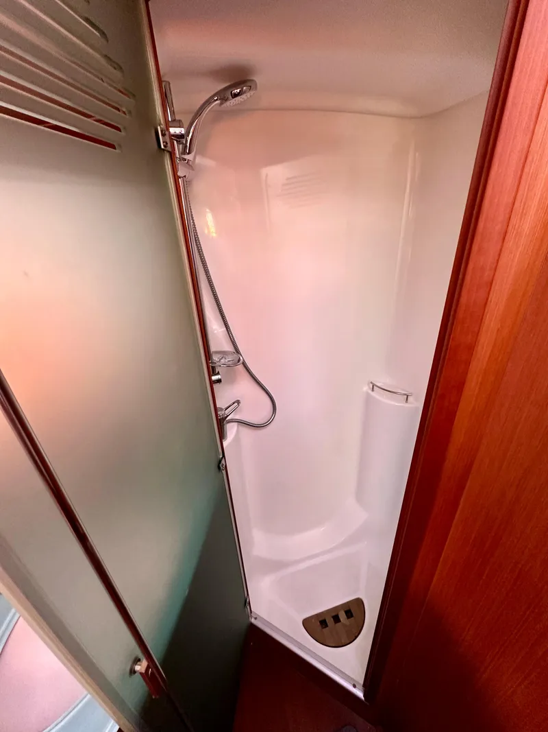 Slide: The Image of Shower area in a 2010 Beneteau 57 yacht, featuring sleek design and modern fixtures. - 45