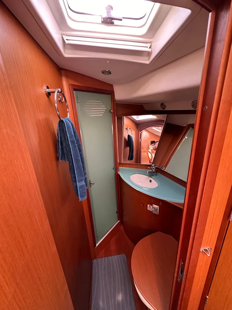 Slide: The Image of Beneteau 57 yacht bathroom, 2010 model, featuring wood finish and modern fixtures. - 48