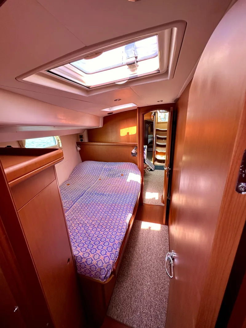 Slide: The Image of Interior cabin of 2010 Beneteau 57 yacht with bed and skylight. - 49