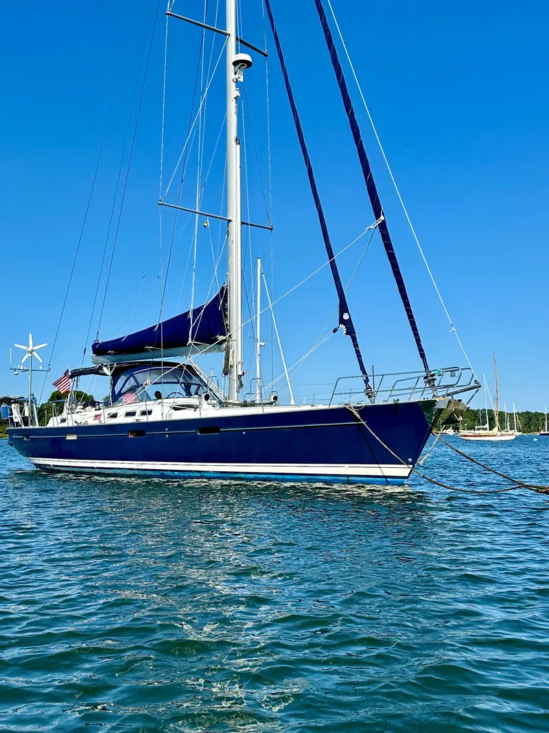 Slide: The Image of 2010 Beneteau 57 sailboat on calm water under clear blue sky. - 5