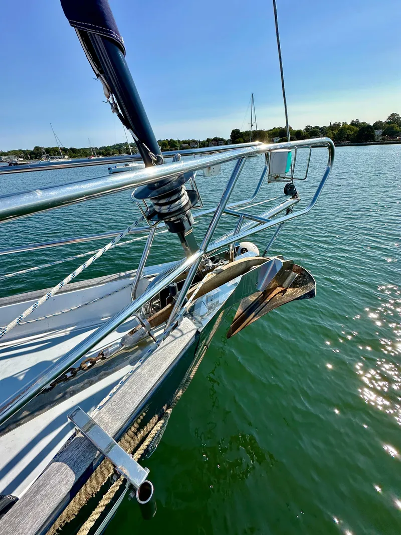 Slide: The Image of Beneteau 57 sailboat bow with anchor, 2010 model, on calm water under clear sky. - 9