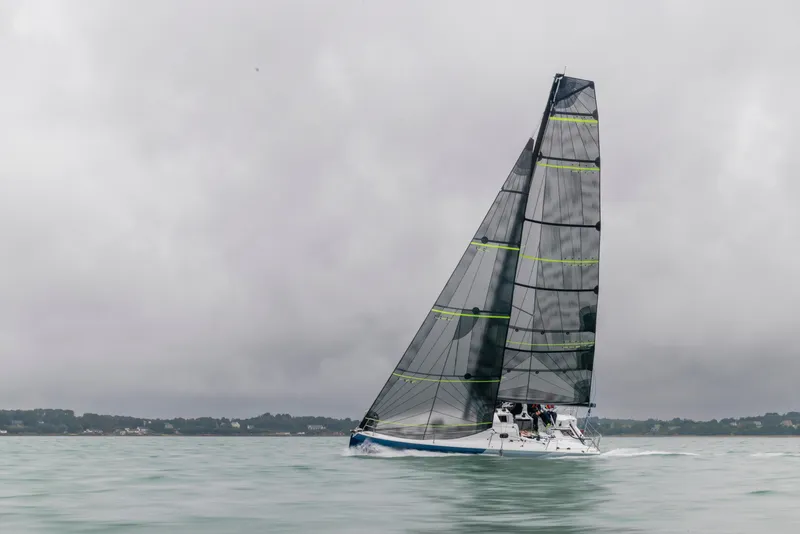 Slide: The Image of 2025 Jeanneau 30 Sun Fast One Design sailing on calm waters under cloudy skies. - 7