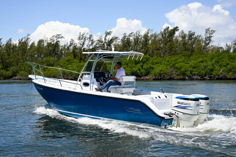 The Image of 1999 Boston Whaler 26 boat cruising on water with Suzuki outboard engines. - 0