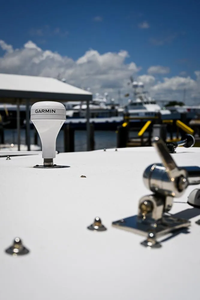 Slide: The Image of 1999 Boston Whaler 26 boat with Garmin equipment at a marina. - 12