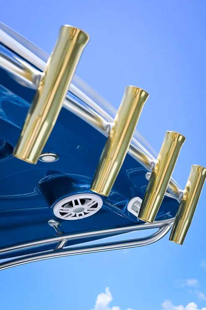 Slide: The Image of Boston Whaler 26 boat, 1999 model, with gold rod holders against blue sky. - 13