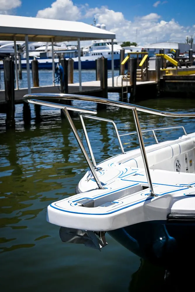 Slide: The Image of 1999 Boston Whaler 26 boat docked at marina under clear blue sky. - 14