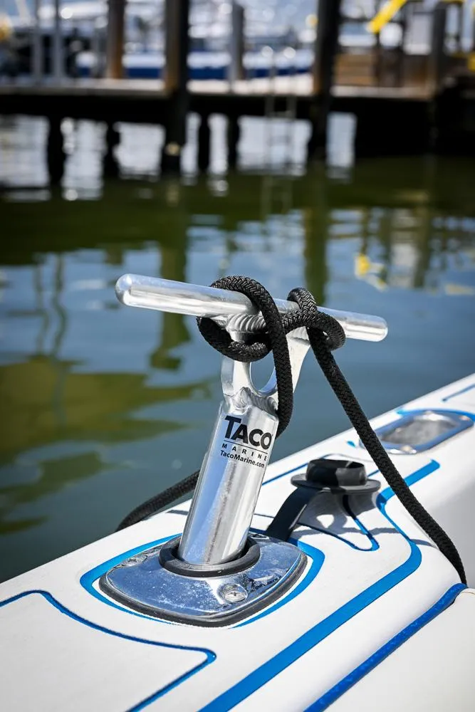 Slide: The Image of 1999 Boston Whaler 26 boat cleat with rope, docked by the water. - 16