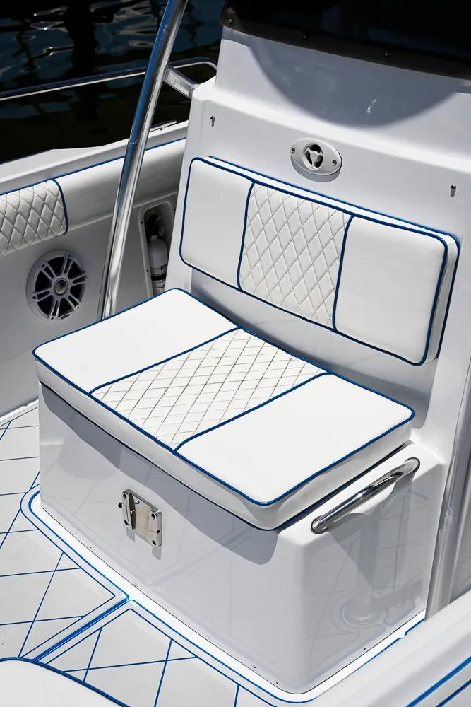 Slide: The Image of 1999 Boston Whaler 26 boat seat with white and blue diamond-patterned upholstery. - 17
