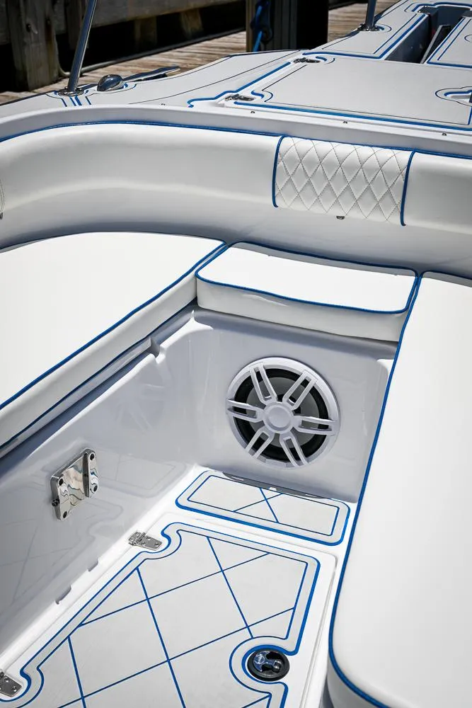 Slide: The Image of 1999 Boston Whaler 26 boat interior with cushioned seating and speaker. - 18