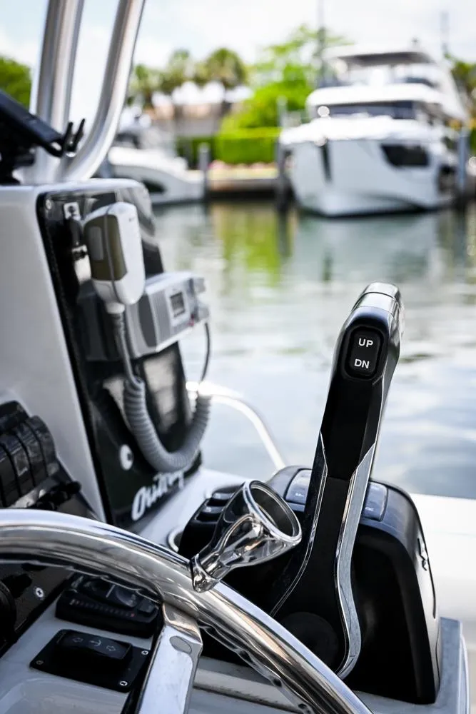 Slide: The Image of 1999 Boston Whaler 26 boat controls with marina view in the background. - 6
