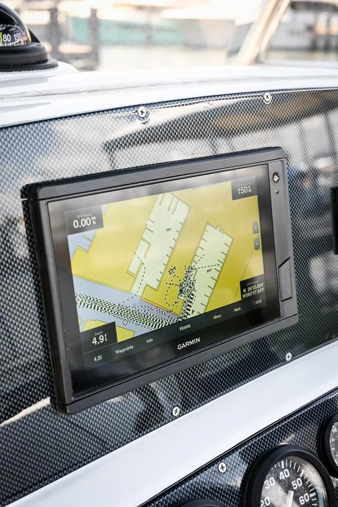 Slide: The Image of 1999 Boston Whaler 26 dashboard with Garmin navigation display. - 8