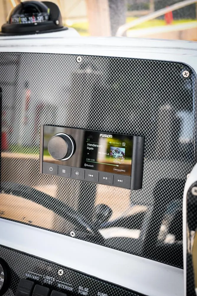 Slide: The Image of Fusion stereo system on 1999 Boston Whaler 26 dashboard with carbon fiber finish. - 9