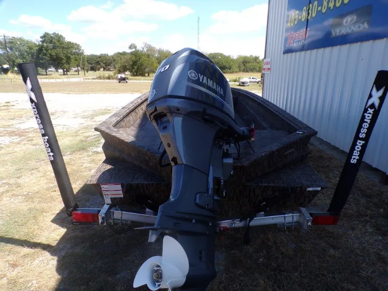Slide: The Image of 2025 Xpress H18DB boat with Yamaha outboard motor, parked outdoors. - 1