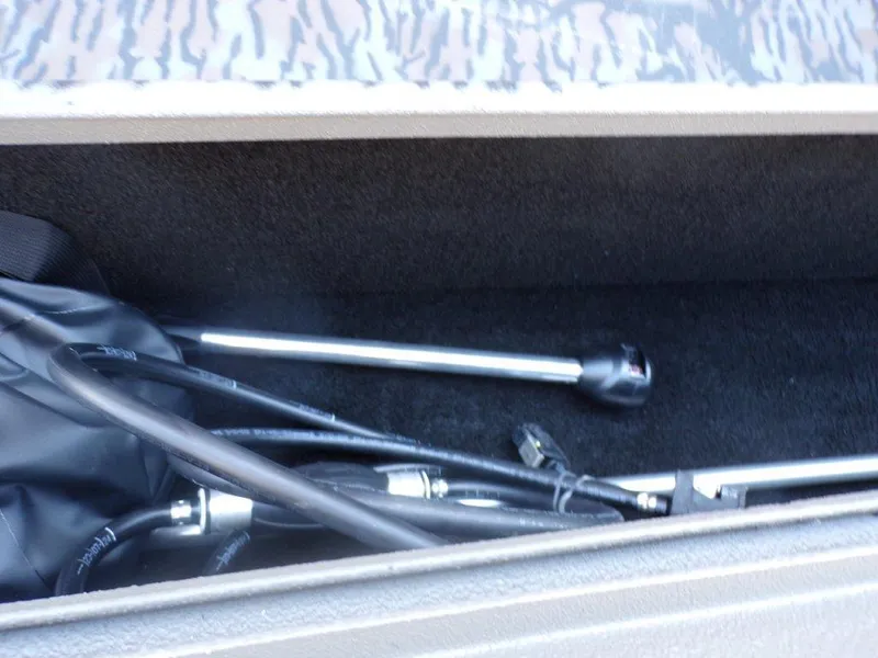 Slide: The Image of Storage compartment of 2025 Xpress H18DB boat with equipment and cables. - 12