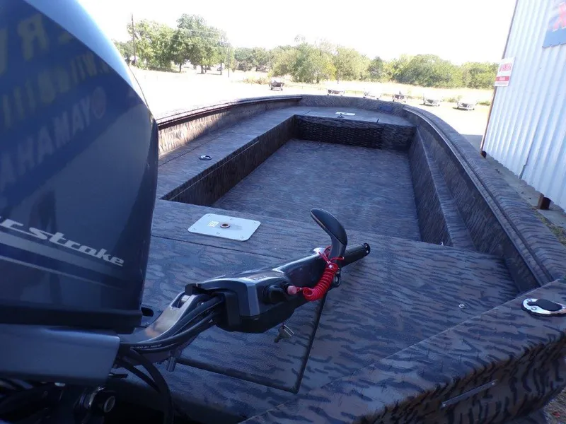 Slide: The Image of 2025 Xpress H18DB boat with camo design and outboard motor. - 3