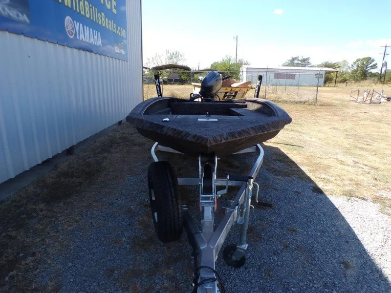 Slide: The Image of 2025 Xpress H18DB boat on trailer, parked outdoors near a building. - 9