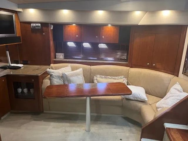 Slide: The Image of Interior of 2008 Cruisers Yachts 460 Express with cozy seating and wooden table. - 12