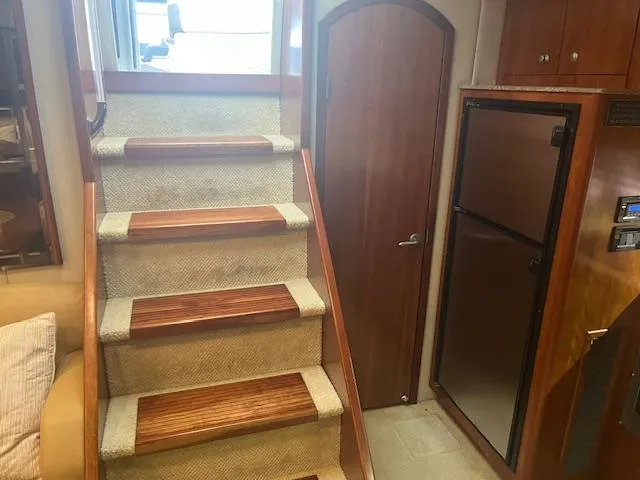 Slide: The Image of Interior of 2008 Cruisers Yachts 460 Express, featuring stairs and a compact kitchen area. - 14