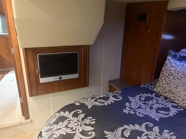 Slide: The Image of Luxurious 2008 Cruisers Yachts 460 Express cabin with TV and elegant bedding. - 16
