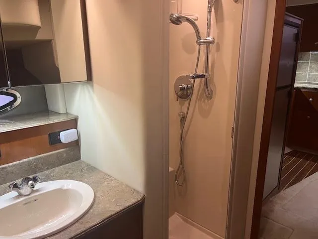 Slide: The Image of Luxurious bathroom in 2008 Cruisers Yachts 460 Express with shower and sink. - 19