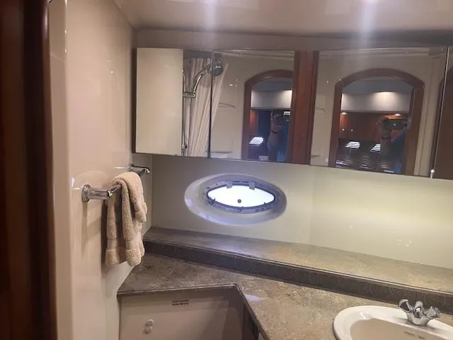 Slide: The Image of Luxurious bathroom in 2008 Cruisers Yachts 460 Express with mirror and porthole. - 21