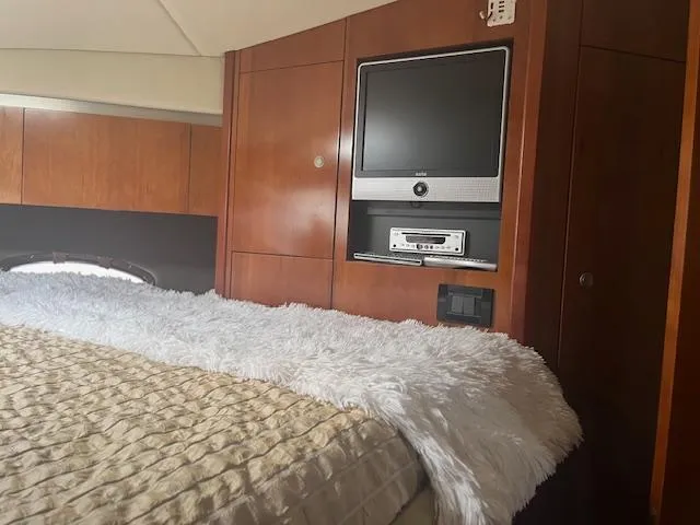 Slide: The Image of Luxurious 2008 Cruisers Yachts 460 Express cabin with TV and cozy bedding. - 23