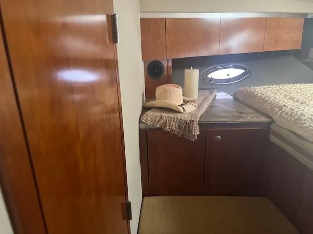Slide: The Image of Interior of 2008 Cruisers Yachts 460 Express with wood cabinetry and cozy bed. - 24
