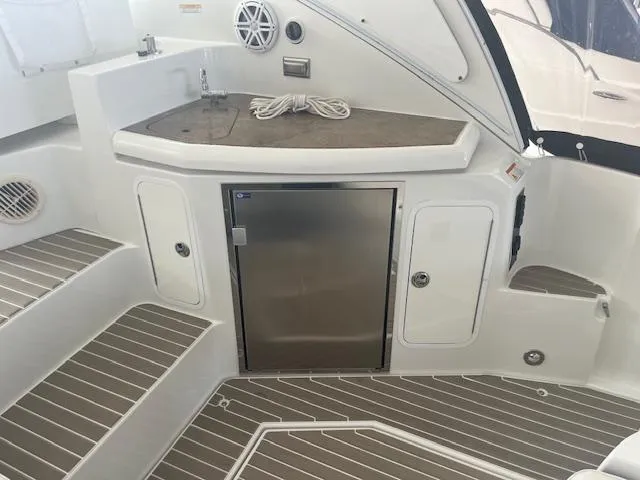 Slide: The Image of 2008 Cruisers Yachts 460 Express interior with kitchenette and stainless steel fridge. - 27