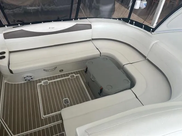 Slide: The Image of 2008 Cruisers Yachts 460 Express interior seating area with cushioned benches and storage. - 28