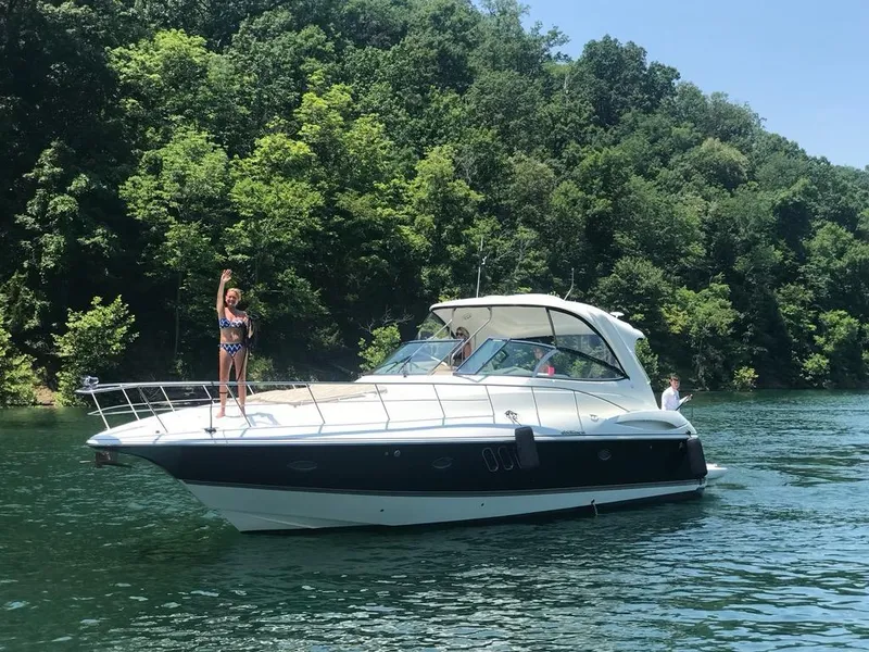 The Image of 2008 Cruisers Yachts 460 Express on a scenic lake with lush greenery. - 0