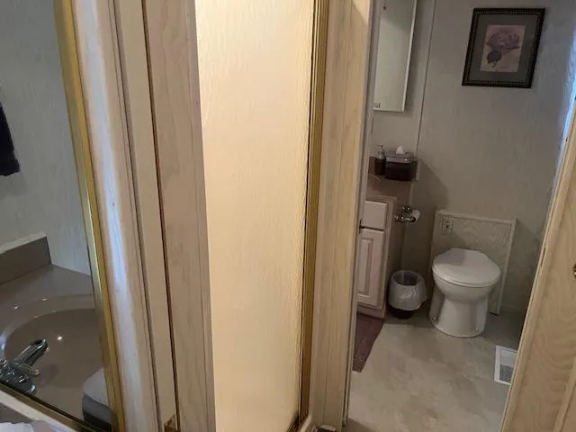 Slide: The Image of Bathroom interior of 2000 Sharpe 16X80 houseboat with sink, toilet, and decor. - 12