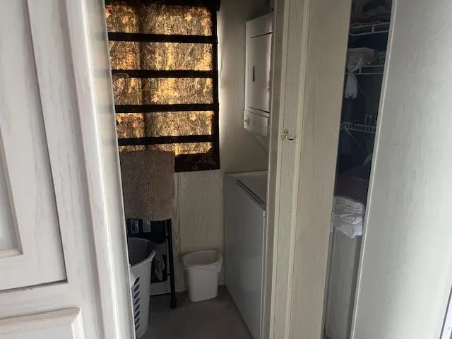 Slide: The Image of Laundry area in 2000 Sharpe 16X80 houseboat with stacked washer and dryer. - 15