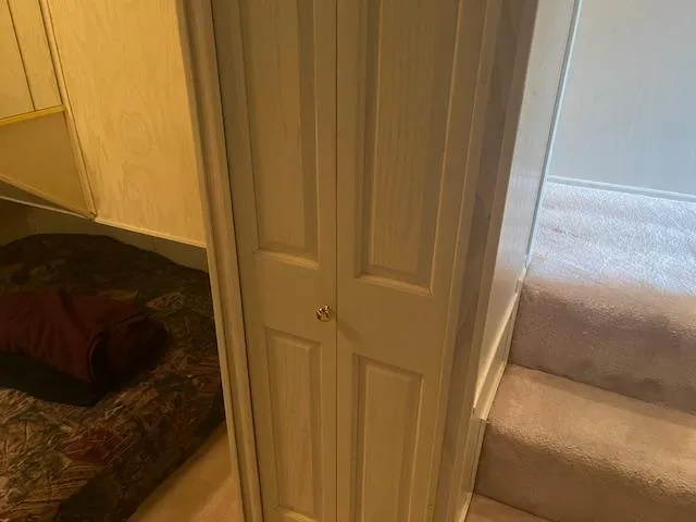 Slide: The Image of Interior of 2000 Sharpe 16X80 houseboat with stairs and closet. - 19