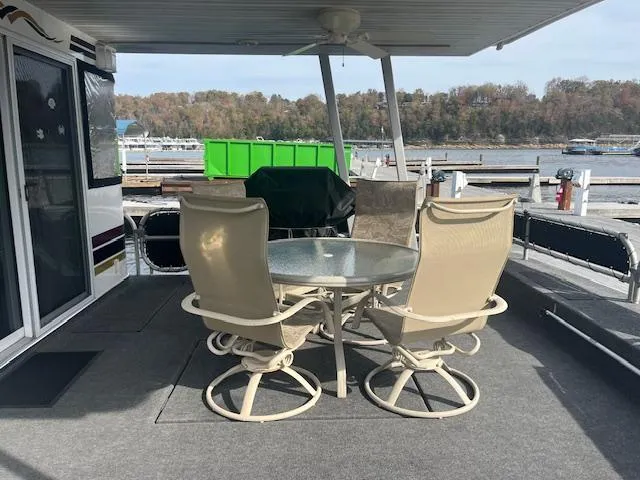 Slide: The Image of Outdoor seating area on 2000 Sharpe 16X80 houseboat with lake view. - 2