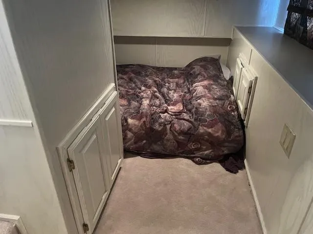 Slide: The Image of Cozy bedroom in 2000 Sharpe 16X80 houseboat with patterned bedding and storage cabinets. - 20