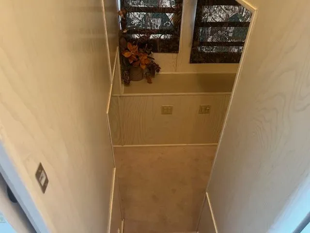 Slide: The Image of Narrow hallway in 2000 Sharpe 16X80 houseboat with floral decor and windows. - 22