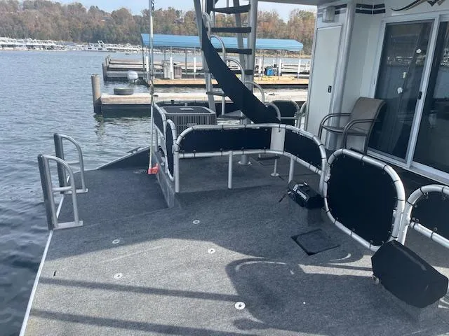 Slide: The Image of Sharpe 16X80 houseboat deck with railing, chairs, and water view, year 2000. - 27