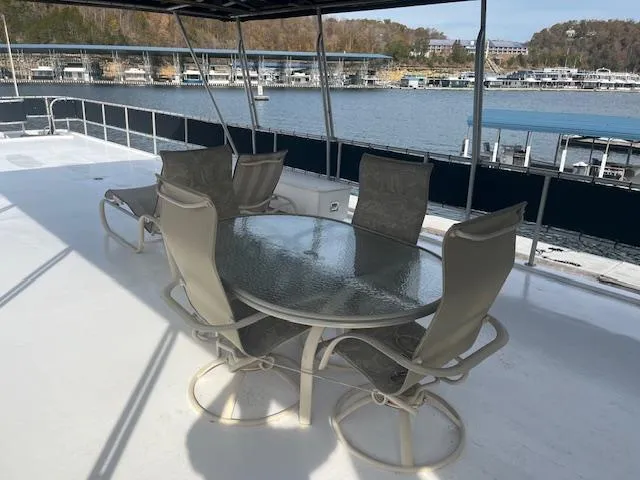 Slide: The Image of Outdoor seating on 2000 Sharpe 16X80 houseboat deck, overlooking marina and water. - 28