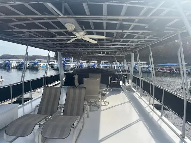 Slide: The Image of 2000 Sharpe 16X80 houseboat deck with lounge chairs and marina view. - 29