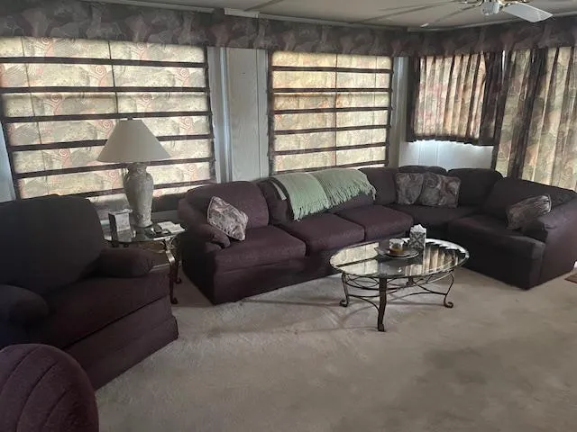 Slide: The Image of Cozy living area in 2000 Sharpe 16X80 houseboat with plush seating and elegant decor. - 5