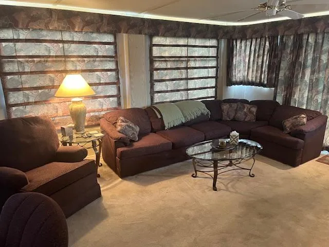 Slide: The Image of Cozy living area in 2000 Sharpe 16X80 houseboat with sectional sofa and lamp. - 6