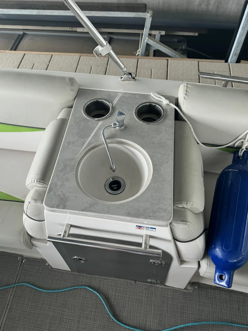 Slide: The Image of 2018 Starcraft Starstep 221 boat interior with sink and cup holders. - 11