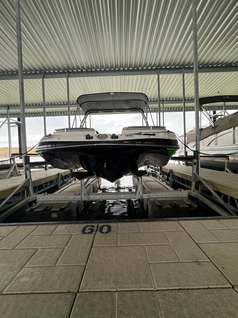Slide: The Image of 2018 Starcraft Starstep 221 boat docked in a covered marina slip. - 3