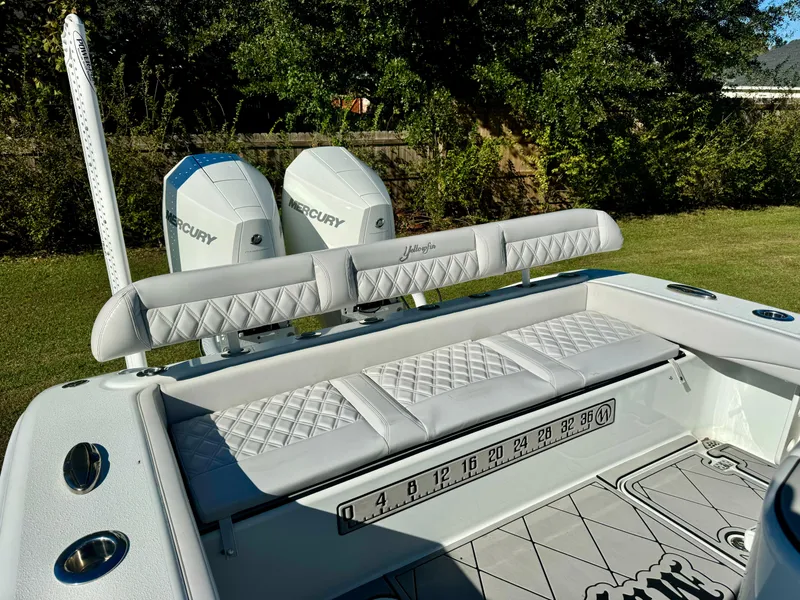 Slide: The Image of 2020 Yellowfin 26 Hybrid boat with dual Mercury engines and cushioned seating. - 12